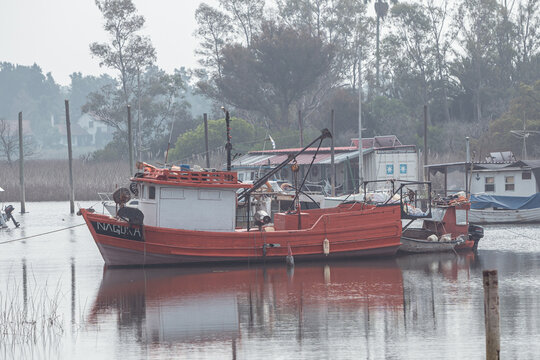 Fishing boats on a Cloudy day in La Barra del Rio Santa Lucia in Montevideo the capital of Uruguay in the year 2023.