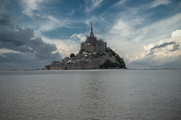 Picturesque view of Mont-Saint-Michel tidal island against a beautiful cloudy sky