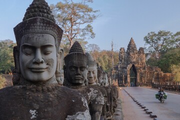 Beautiful shot of the Buddhist sculptures at Angkor Wat temple complex in Cambodia - obrazy, fototapety, plakaty