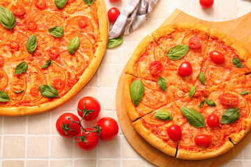 Board with tasty pizzas margarita on beige tile background