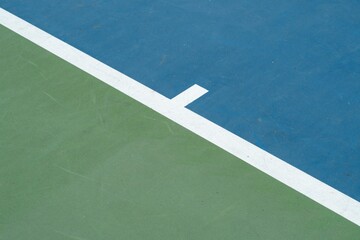 Landscape of a blue and green tennis court on a sunny day