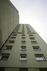 Tall building with several windows on the side of it