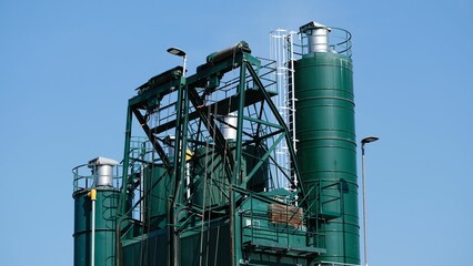 Closeup shot of a cement factory under a blue sky