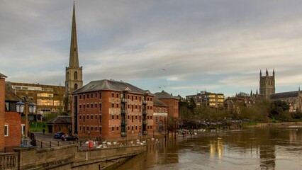 Beautiful view of Worcester City in England with a river under a darkening cloudy sky