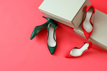 Cardboard boxes with different high-heeled shoes on red background