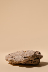 Decorative stone podium on beige background