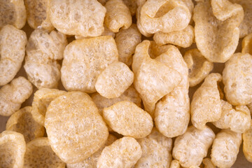 Delicious pile of fried pork cracklings or chicharron top view. Typical Mexican snack. Torreznos, fried pork rinds, typical spanish snack. Chicharrones. Crispy pork skin pieces.
