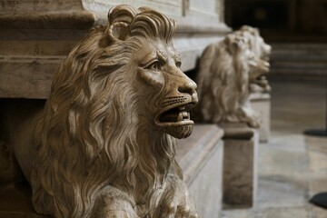Closeup of a lion sculpture inside with blurred background