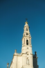 Fototapeta na wymiar Sanctuary of Our Lady of Fatima in Portugal against a blue sky