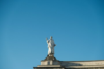 Sculpture on the Sanctuary of Our Lady of Fatima in Portugal against a blue sky