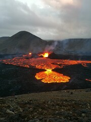 Volcano with lava pouring into the air from a crater