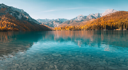 beautiful fairy tale landscape in autumn in europe with a big blue lake