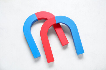 Horseshoe shaped magnets on white background
