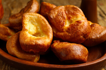 Plate with tasty Yorkshire pudding on wooden background