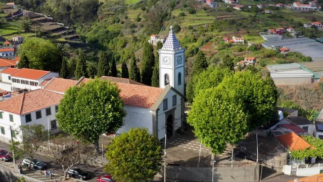 Drone footage of the parish church of Nossa Senhora da Piedade on a sunny day in Canhas, Portugal