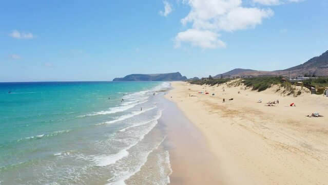 Beautiful aerial view of calm tides washing ashore at Porto Santo Island on a sunny summer day