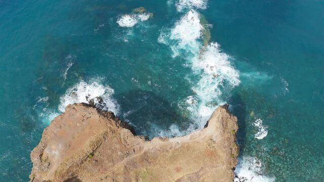 Aerial view of waves splashing on the rocky coastline of Madeira Island, Portugal