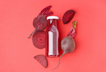 Bottle of healthy beet juice on red background