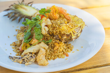 Seafood fried rice in pineapple, appetizing in a cafe next to the sea, Sue Flamingo, Ao Yon Beach, Phuket Thailand