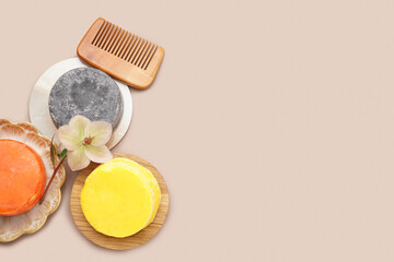 Solid shampoo bars with comb and flower on beige background