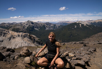 Portrait of a young woman hiking high in the mountains. The Andes cordillera in the background. 