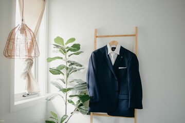 Professional male's suit hanging from the wall in the room