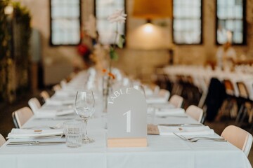Beautiful shot of a dinner table with floral decorations at a wedding venue
