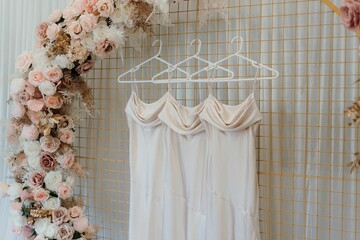 Three white elegant dresses on the hangers