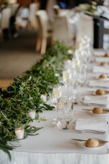 Vertical shot of green plants on an arranged dinner party table