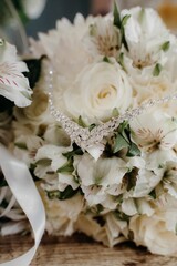 Vertical shot of a precious necklace on beautiful flowers