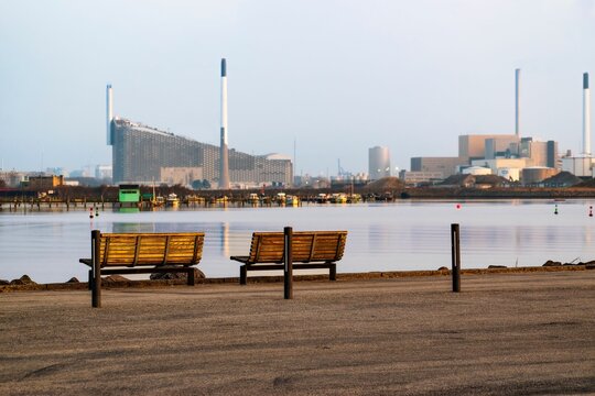 Lakeside benches against the Amager Bakke heat and power energy plant in Copenhagen, Denmark