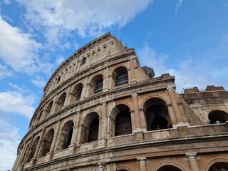 Fototapeta premium Famous Colosseum against the blue sunny sky in Rome, Italy