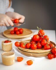 Vertical shot of fresh delicious ripe cherry tomatoes on a wooden board