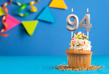 Birthday cake with candle number 94 - Blue background