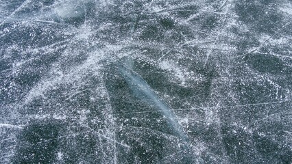 Closeup shot of a frozen lake with scratches on the surface