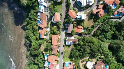 Aerial view of villas and a forest on the coast