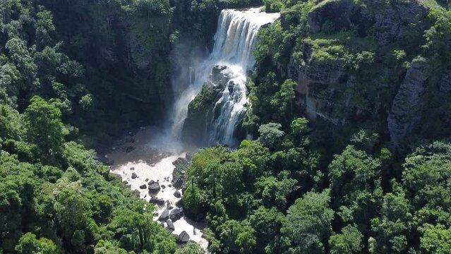 HD aerial view of waterfall surrounded by forests