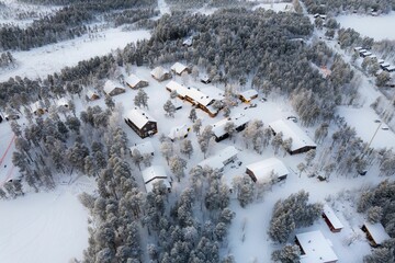 Beautiful view of snowy village with small houses and trees