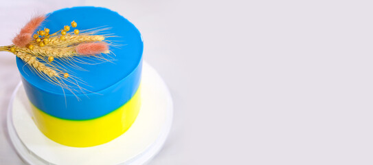 preparation and decoration of a delicious cake dessert with the Ukrainian flag trident and spikelets of wheat and millet on a white background