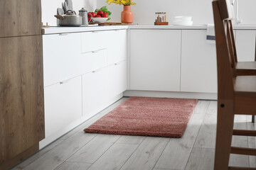Stylish brown carpet in interior of modern kitchen