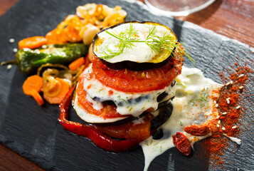 Grilled eggplants with tomatoes, greek yogurt and garlic sauce