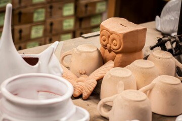 Closeup shot of clay products on a table in a workshop