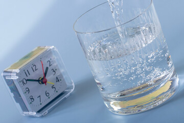 Detail of person filling glass of water. hydration concept