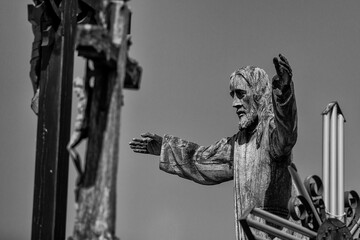 Grayscale shot of a Christian cross at the hill of crosses