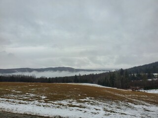 Foggy weather in the mountains on a winter day