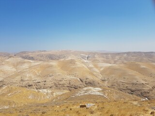 Scenic view of deserted hills under clear cloudless sky