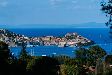 Fototapeta na wymiar Aerial view of town Portoferraio surrounded by buildings and water