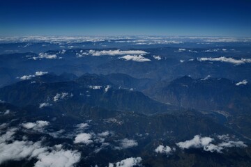 Aerial shot of clouds over the mountains.