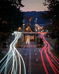 Vertical long exposure shot of car light trails on a road near a downtown crossroad in Bonn, Germany