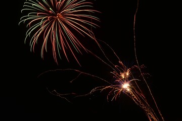 Beautiful shot of exploding colorful fireworks in a black night sky © Ziggy7/Wirestock Creators